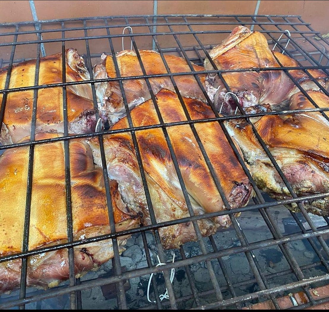 Alabao Eats pork roasting over coals for Cape Coral catering